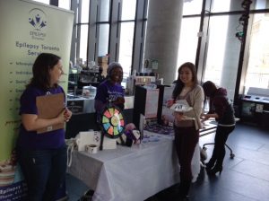 Volunteers and student standing at Epilepsy Toronto information table at U of T