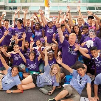 Group of BuskerFest volunteers wearing purple shirts