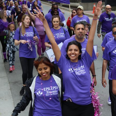 Participants walking down the street in the Purple Walk