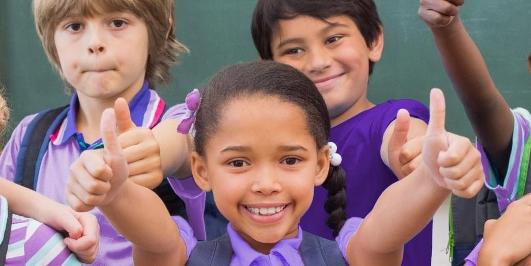 children wearing purple in a classroom