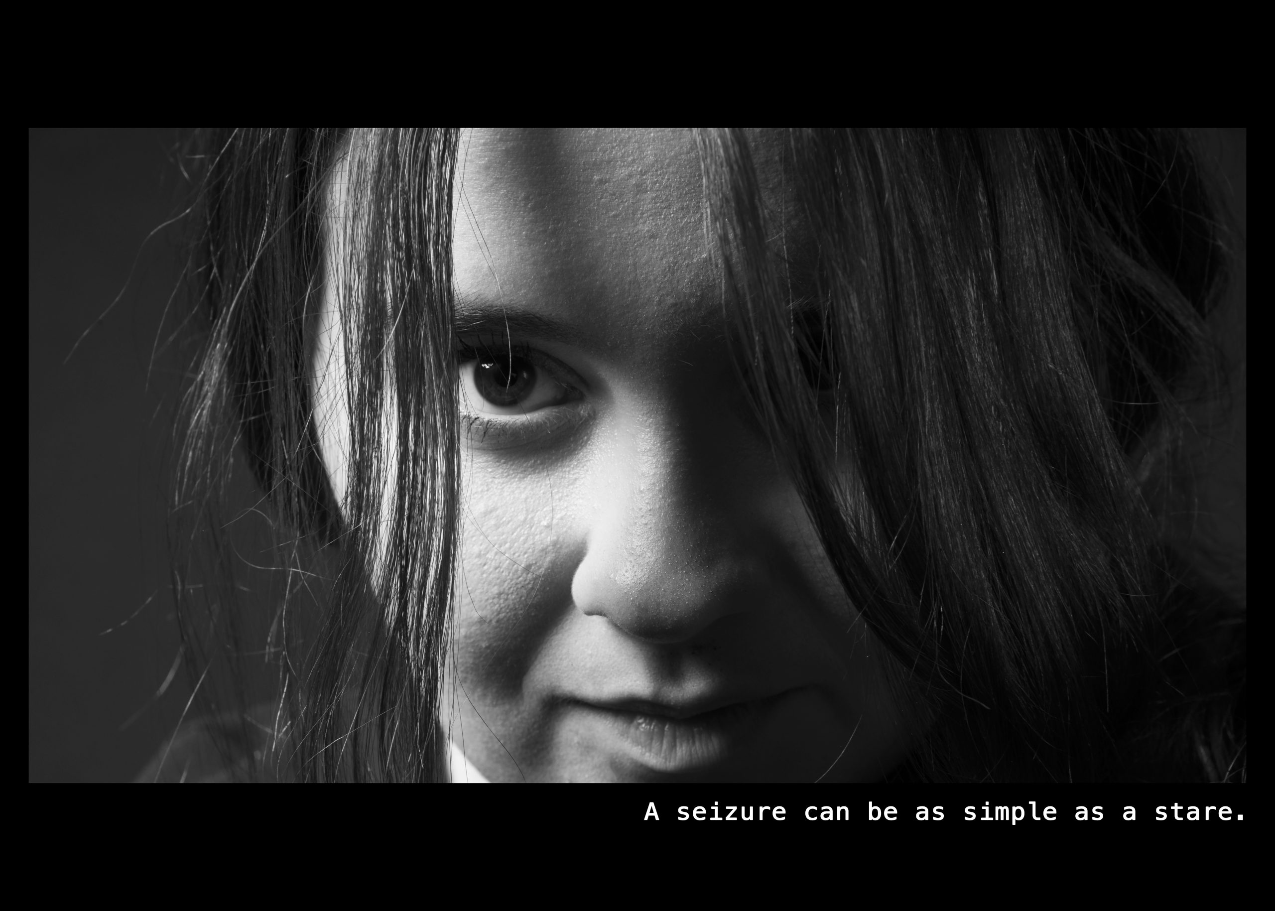 Image of a woman staring directly into the camera Text: A seizure can be as simple as a stare.