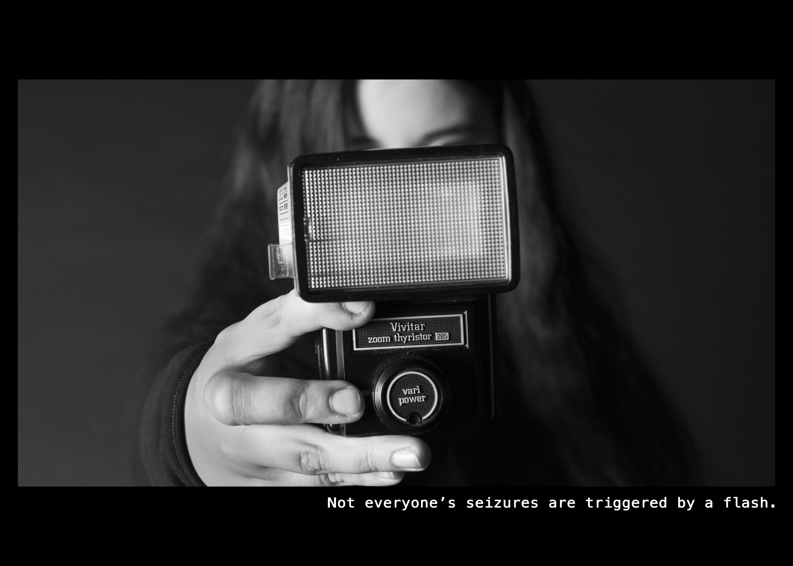 Image of a woman holding a flash for a camera Text: Not everyone's seizures are triggered by a flash.