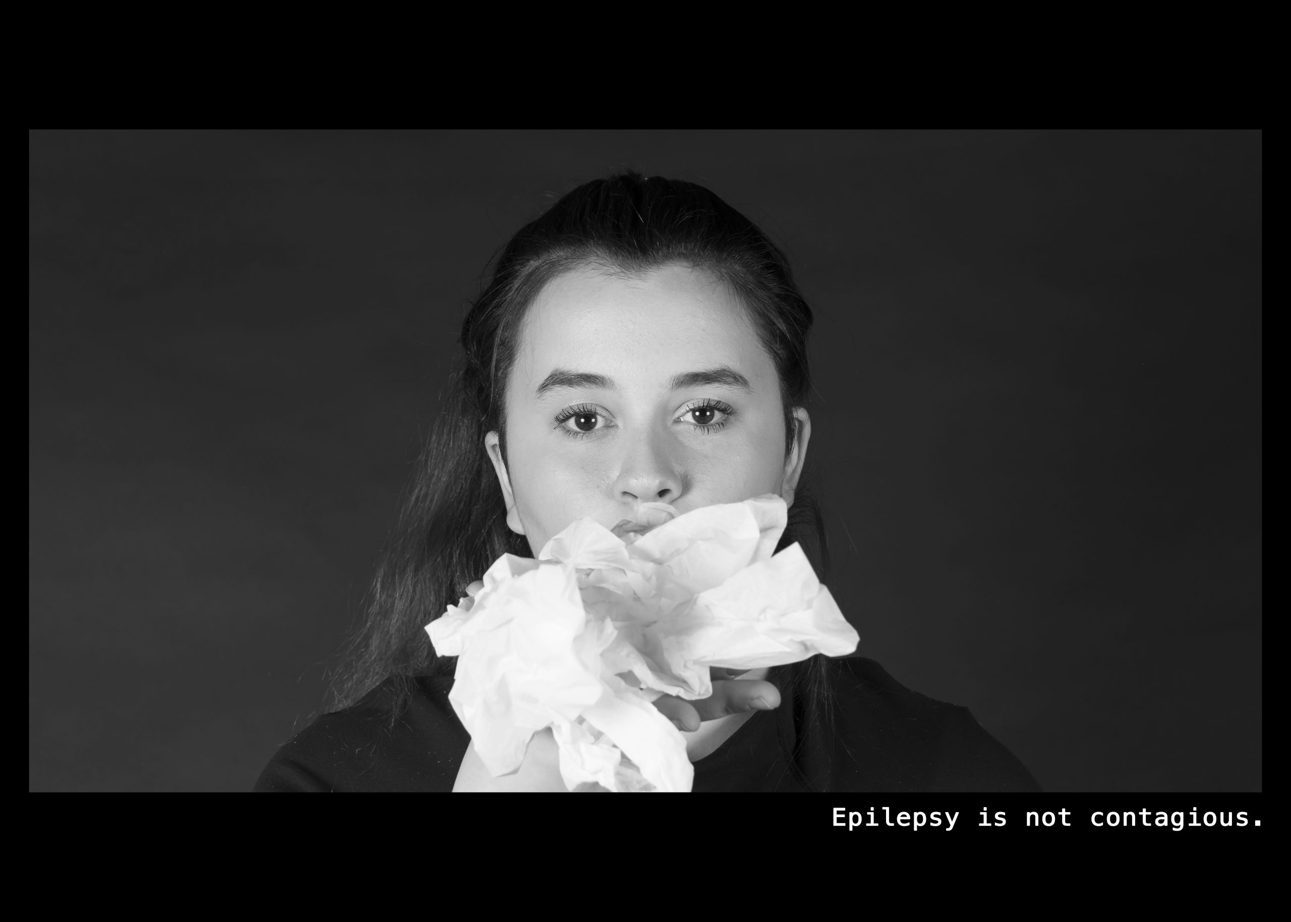 Image of a woman with facial tissues coming out of her mouth. Text: Epilepsy is not contagious.