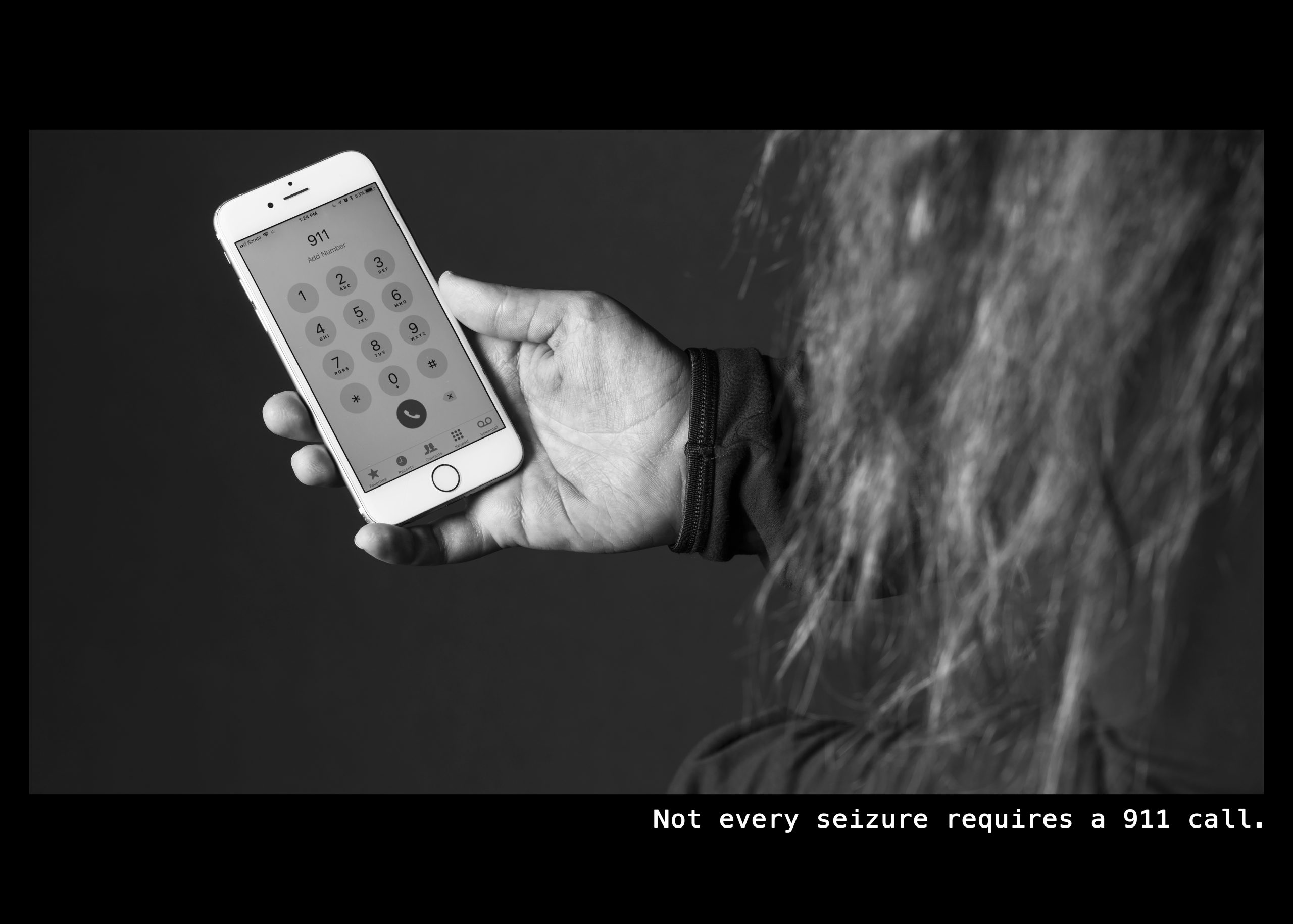 Image of a woman holding her cell phone and preparing to call 911. Text: Not every seizure requires a 911 call.