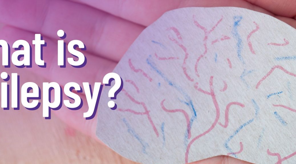 A hand holding a drawing of a brain with the text: What is Epilepsy?